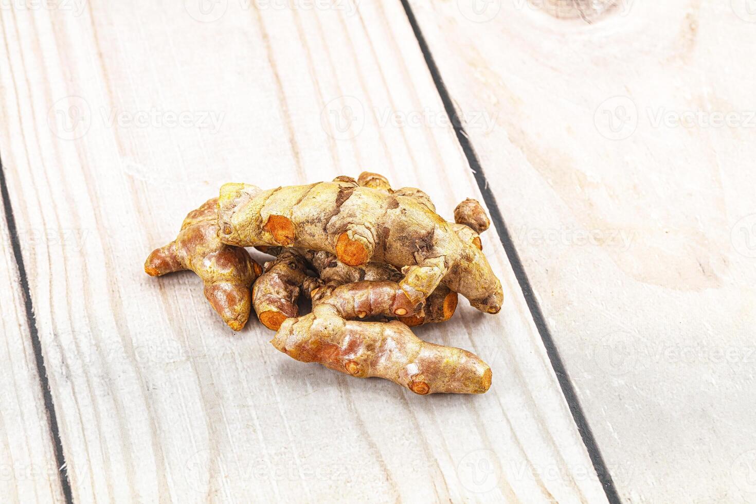 A pile of ginger on a wooden table photo