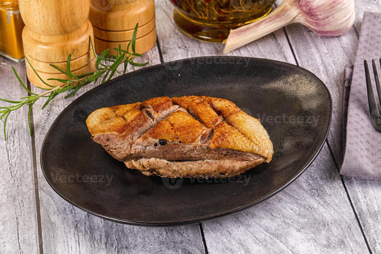 A plate of food on a table with a knife and fork photo