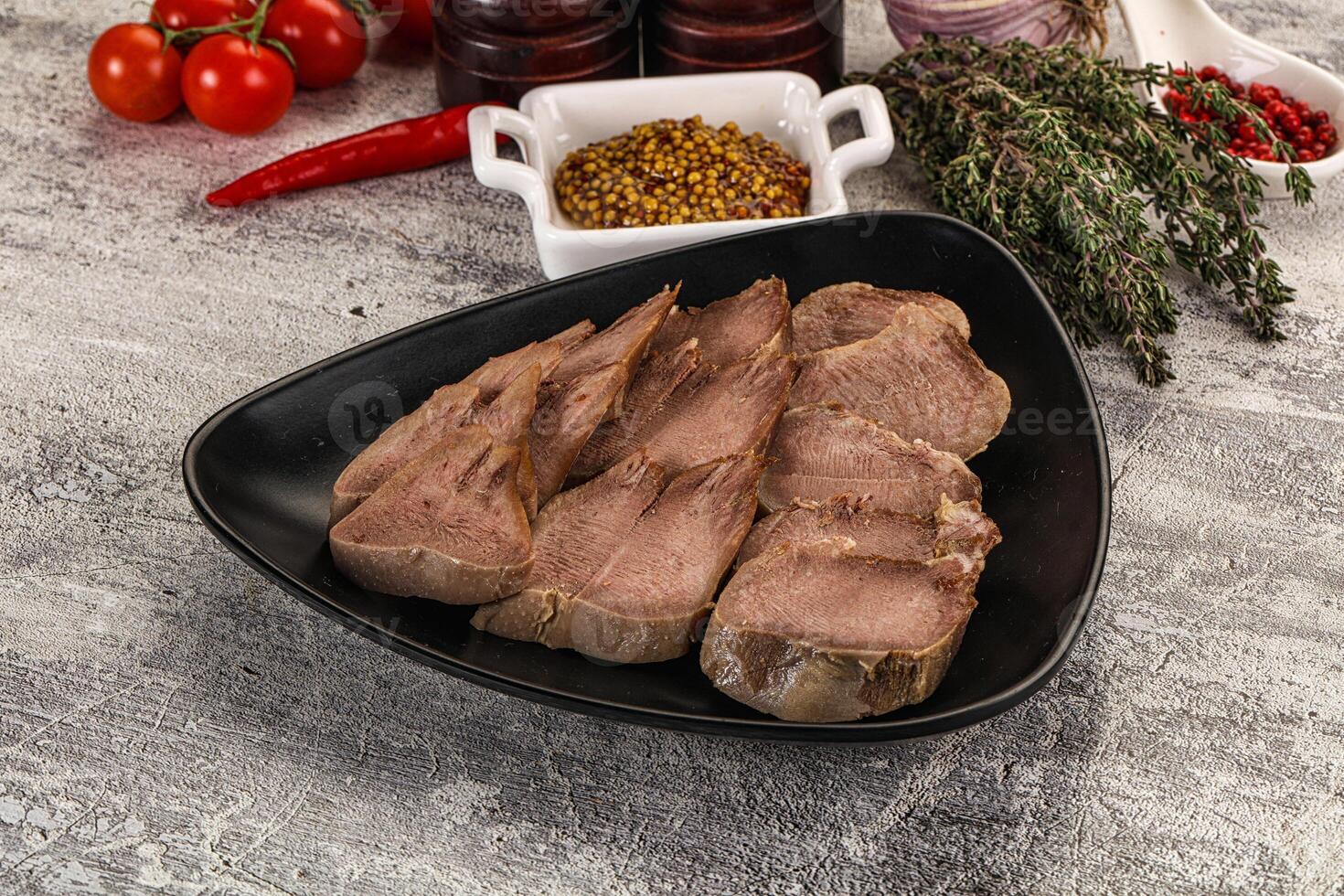 A plate of meat with spices and other ingredients photo