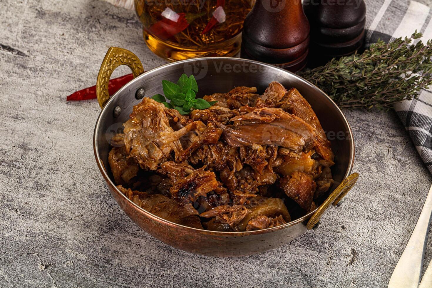 A bowl of meat and spices on a table photo