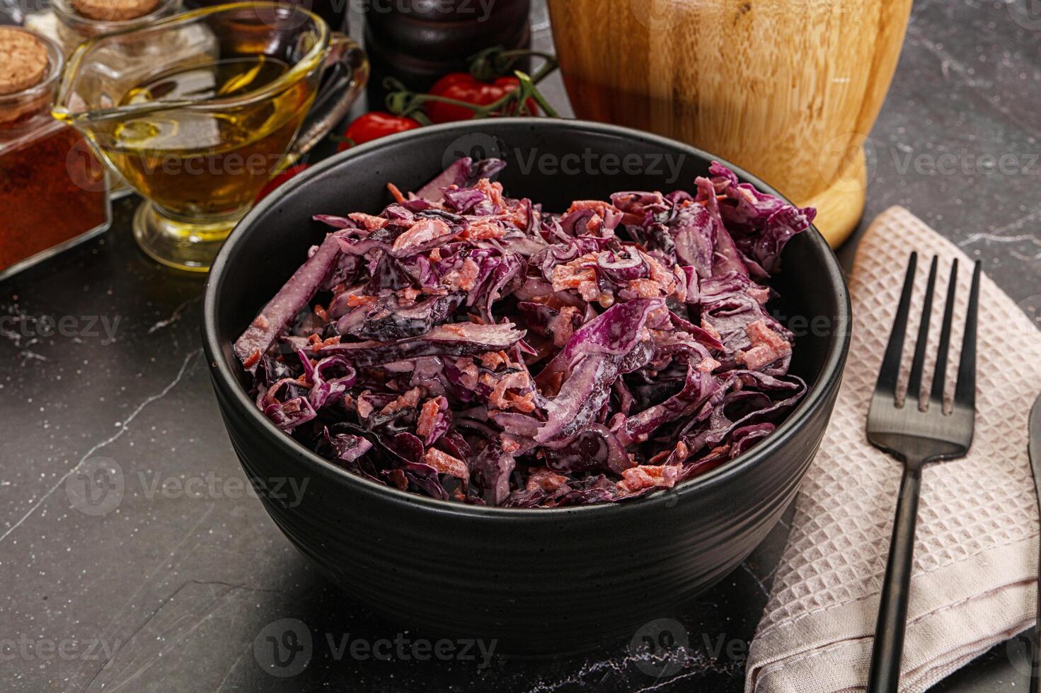 A bowl of red cabbage with a fork and knife photo