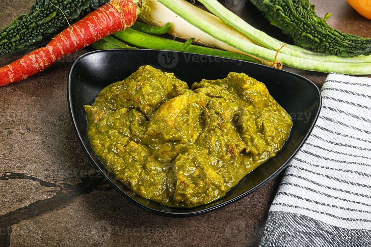 A bowl of food with vegetables and a towel photo