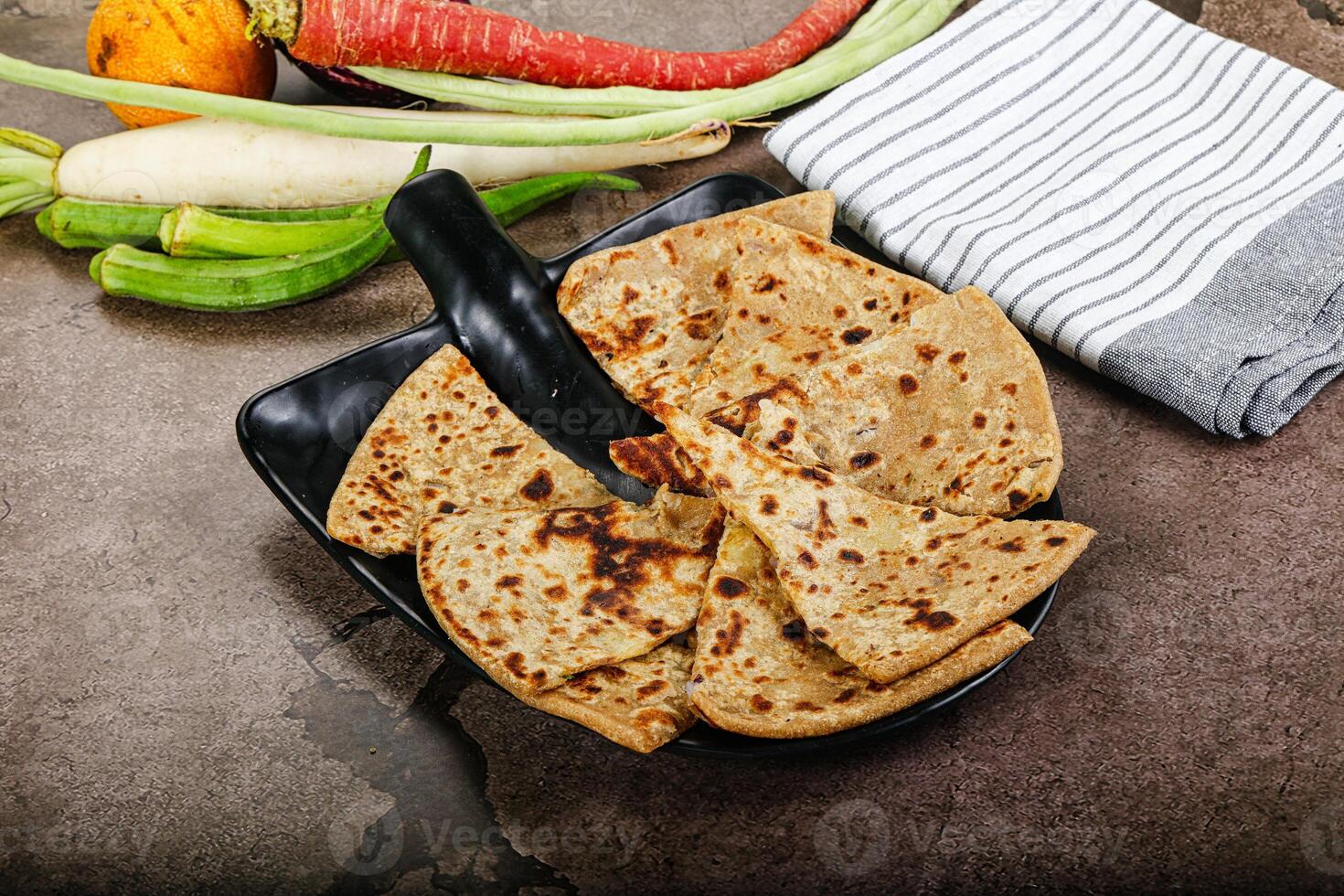 A plate of food with a knife and a towel photo