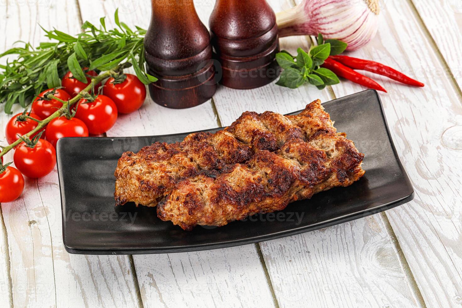 A plate with meat and vegetables on it photo
