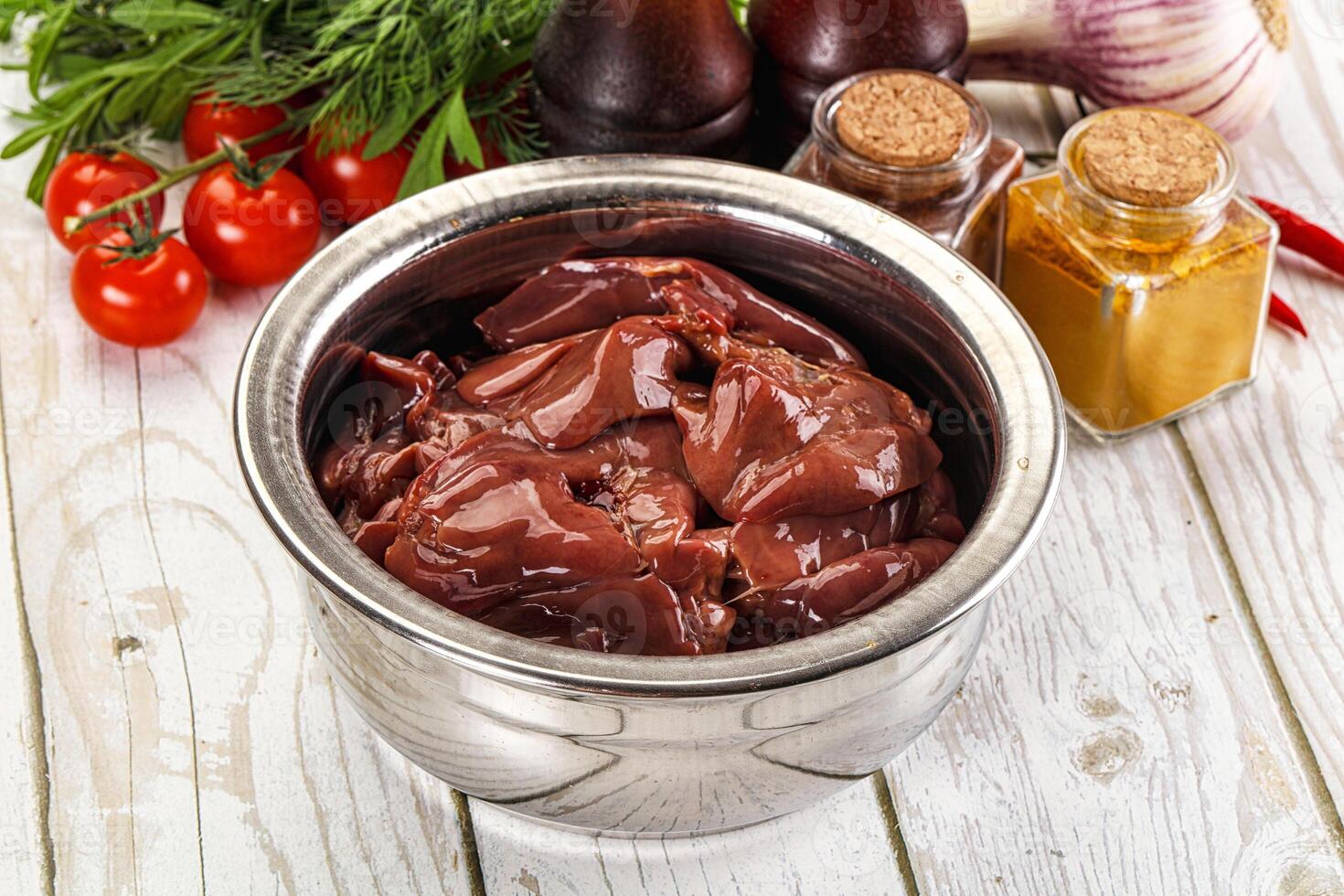 A bowl of meat and vegetables on a table photo