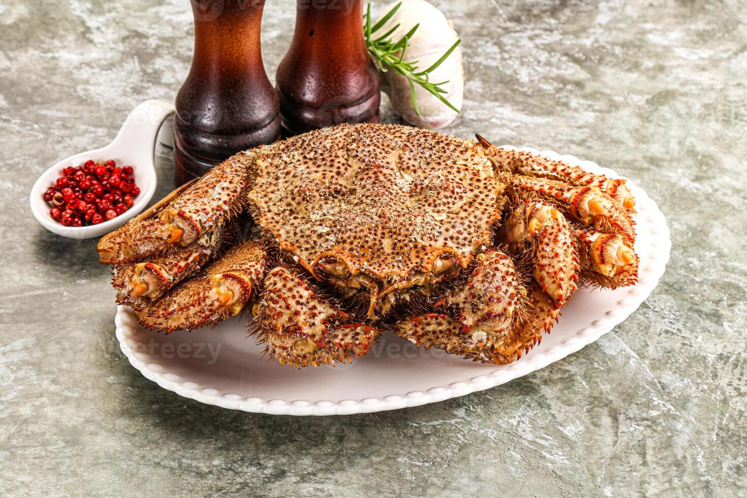 A large crab on a plate with spices photo