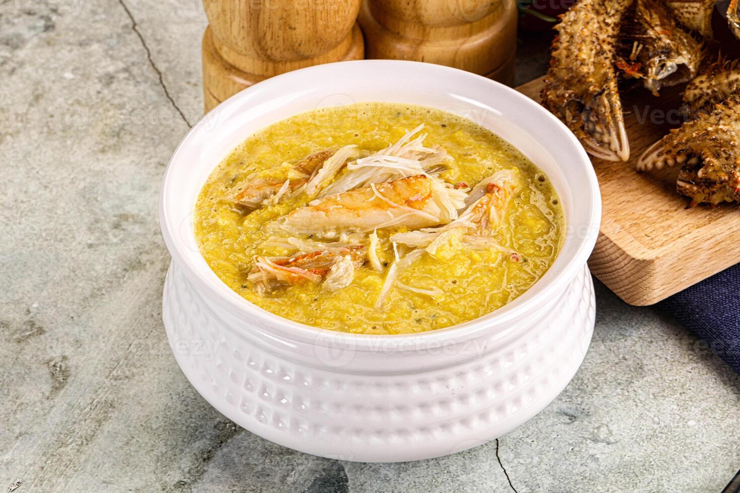 A bowl of soup with a knife and a wooden spoon photo
