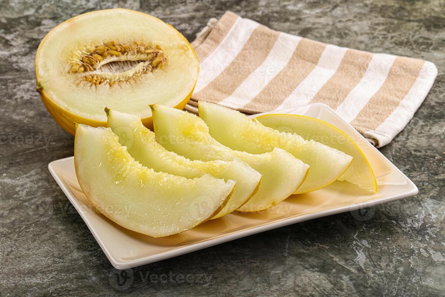 A white plate with a slice of melon on it photo