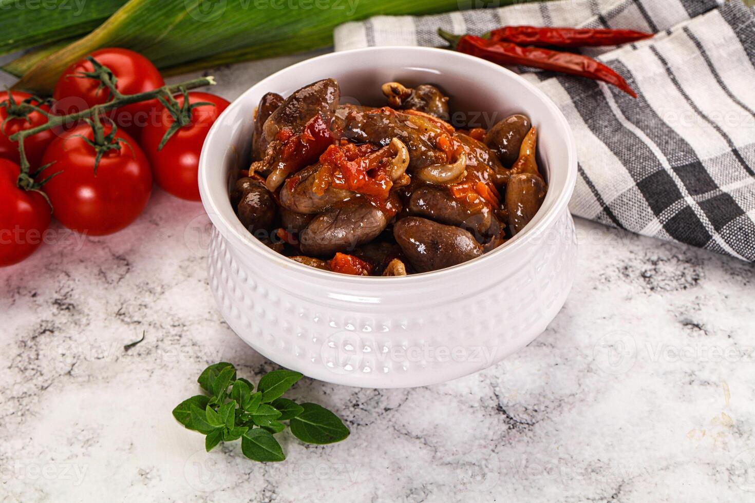 A bowl of beans and tomatoes on a table photo