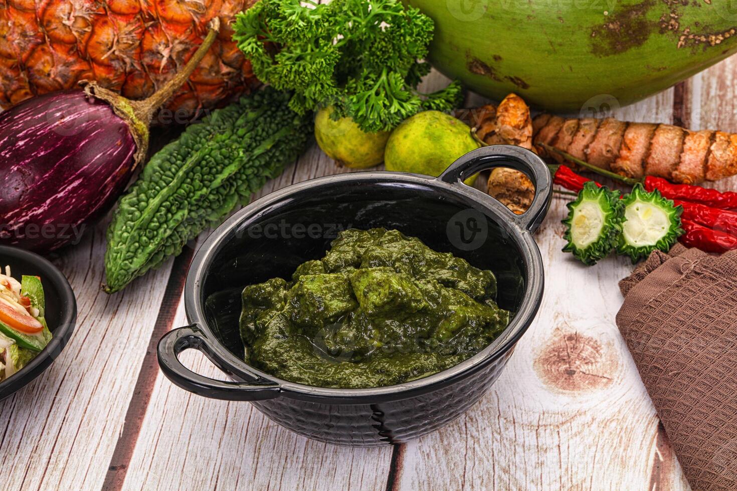 A table with a bowl of food and a bowl of vegetables photo