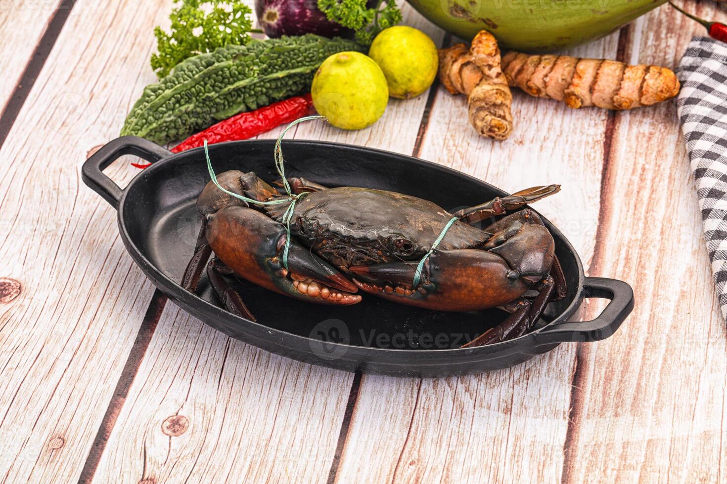 A black cast iron pan with a crab in it photo