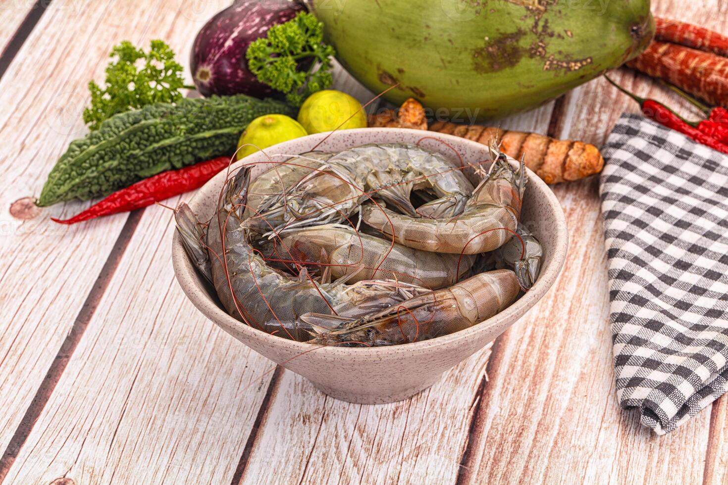 Fresh shrimp in a bowl on a wooden table photo