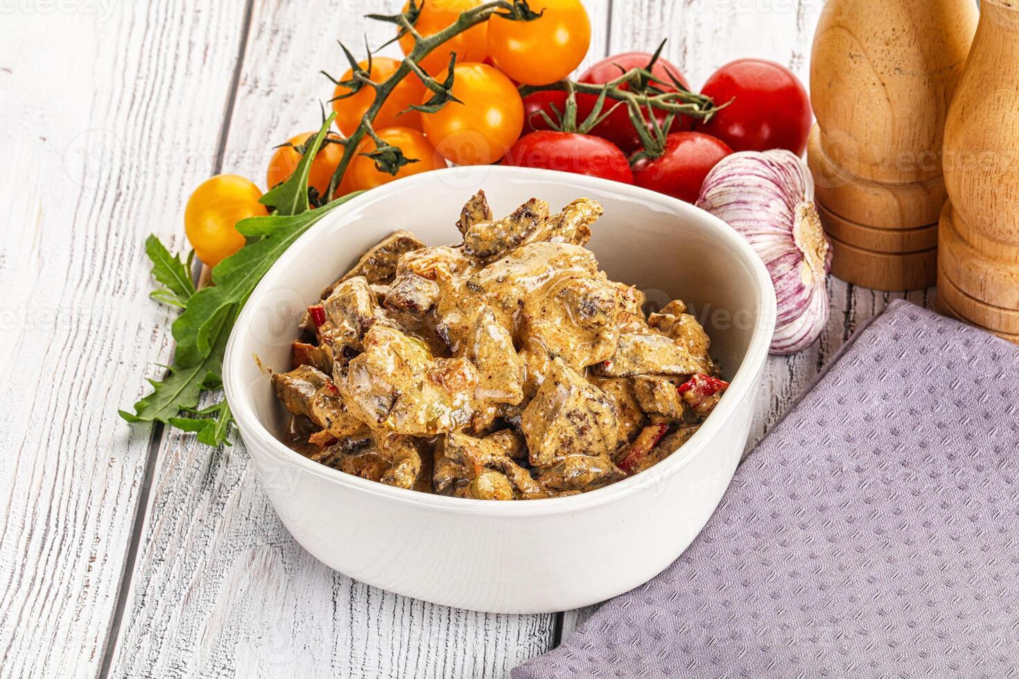 A bowl of food with a knife and a knife sharpener photo
