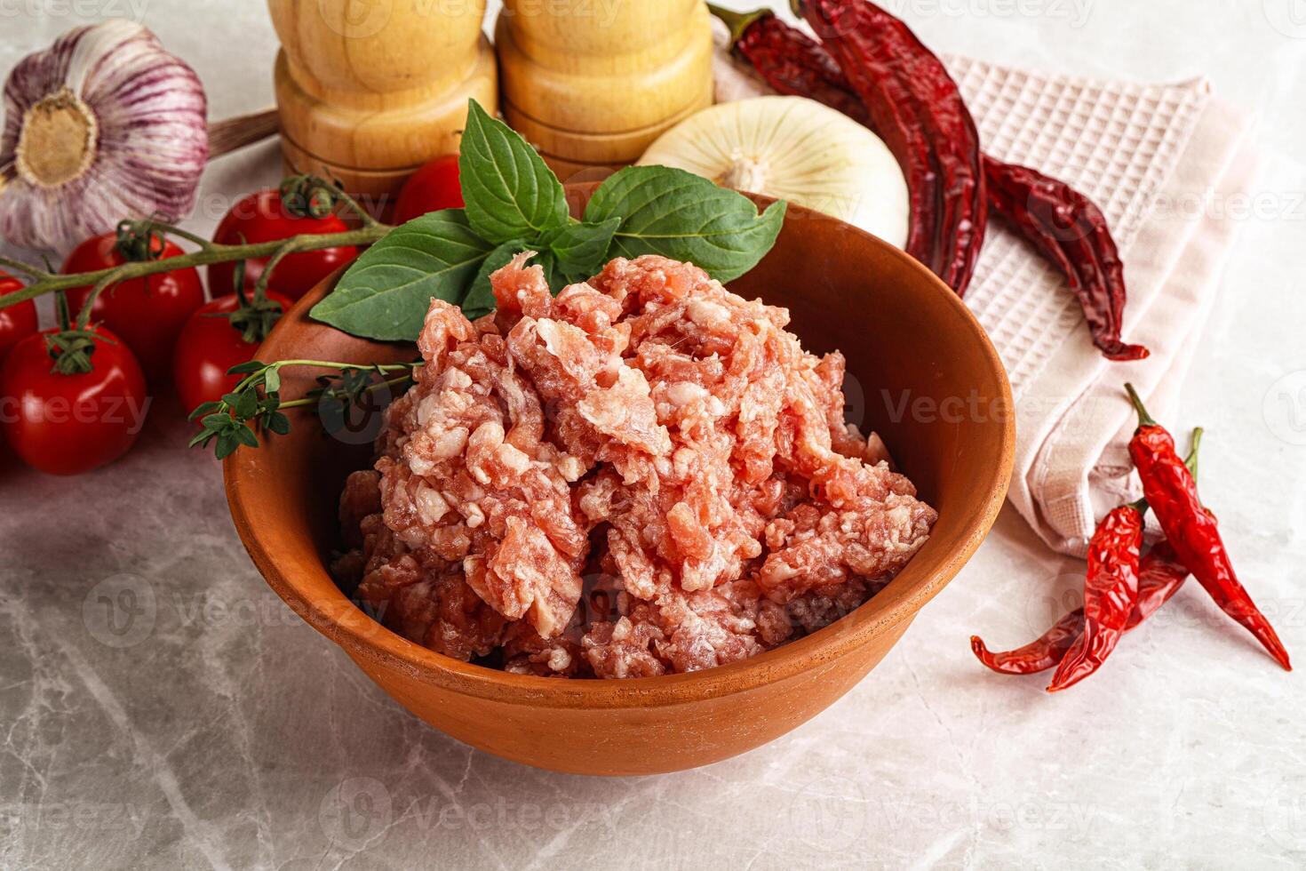 A bowl of meat and vegetables on a marble counter photo