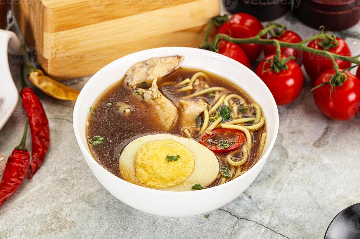 Chicken noodle soup with egg and vegetables photo