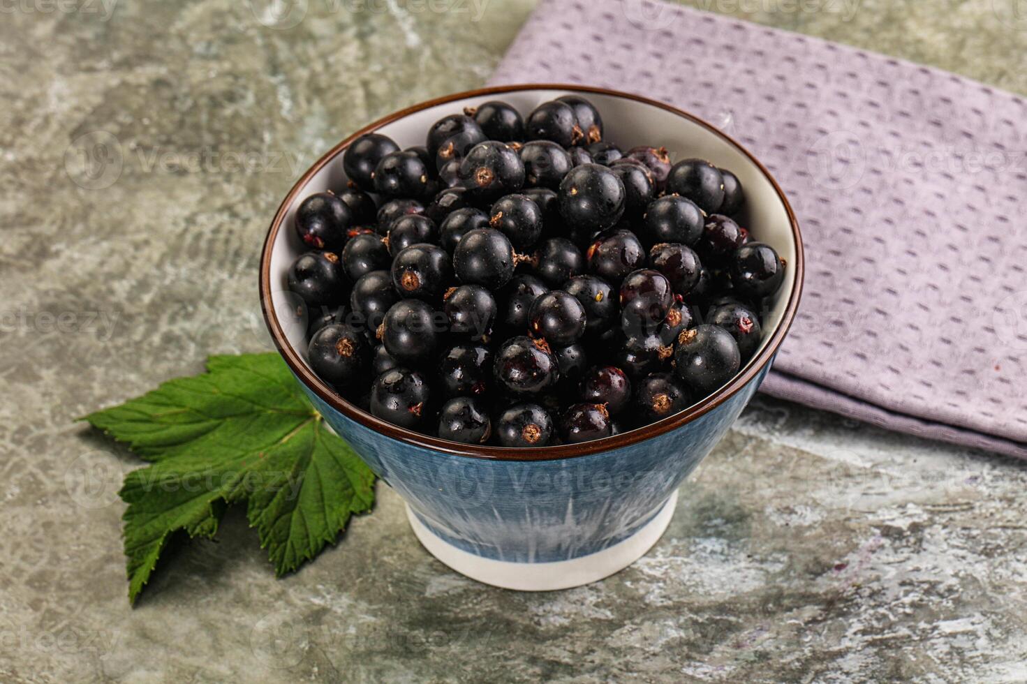 Black currant in a cup on a table photo