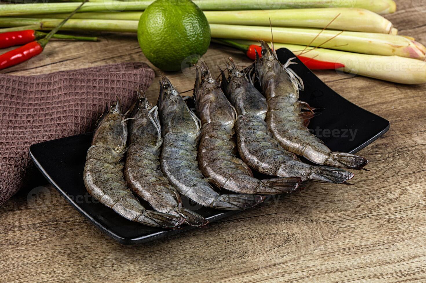 A plate of shrimp and vegetables on a table photo
