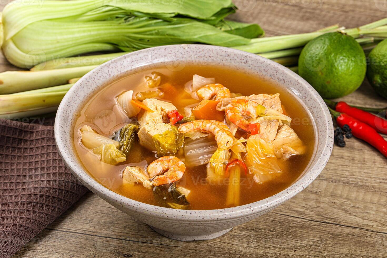 A bowl of soup with vegetables and shrimp photo