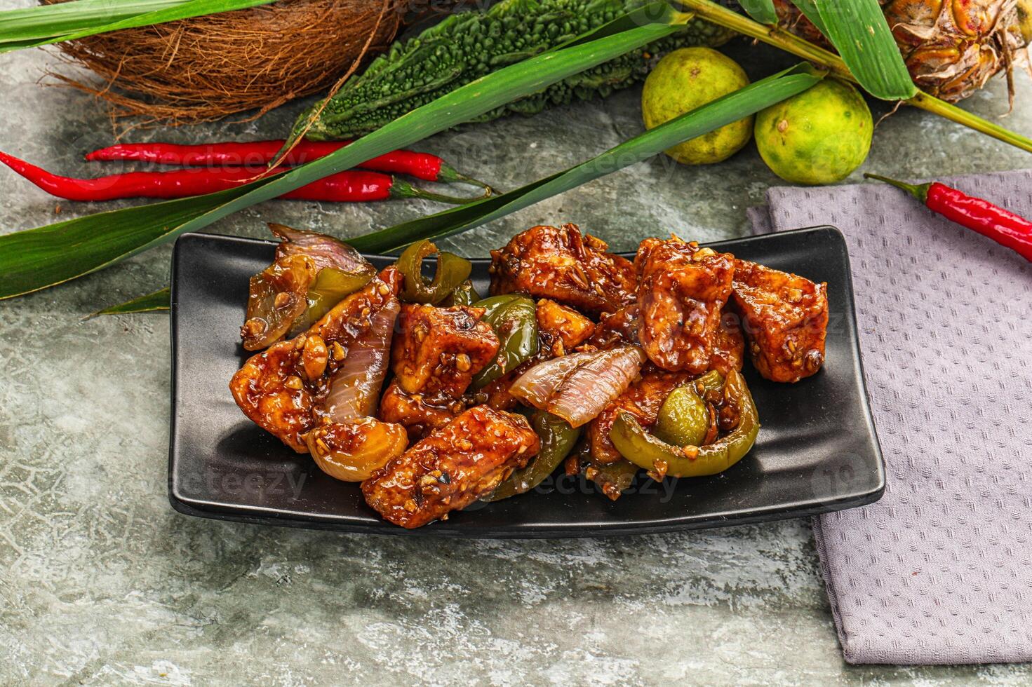 A plate of food with a coconut and some peppers photo
