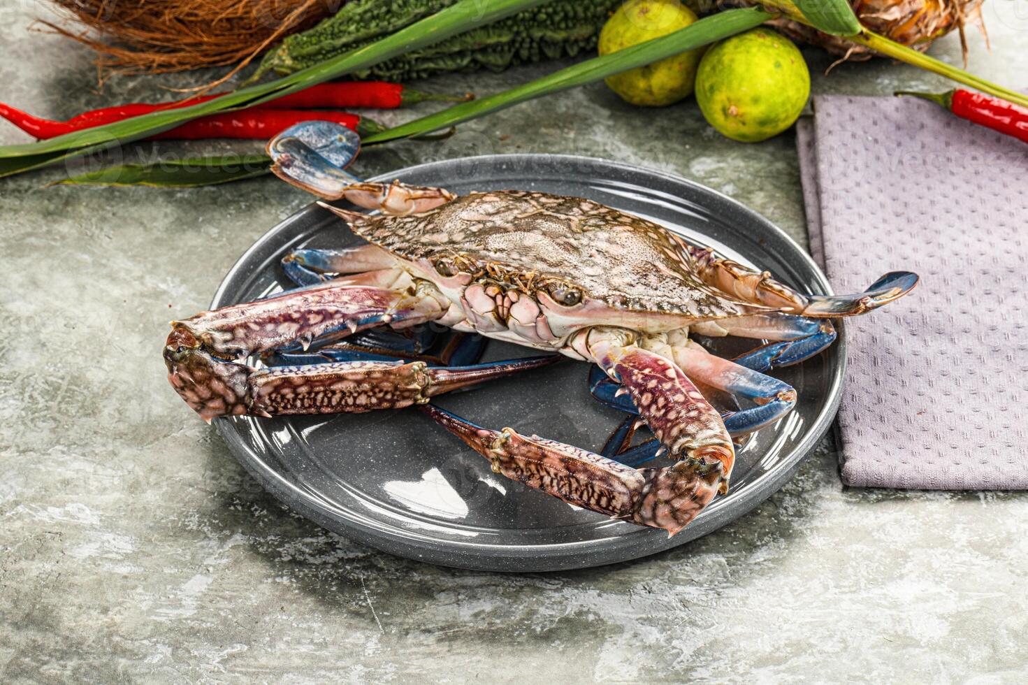 A crab on a plate with other food photo