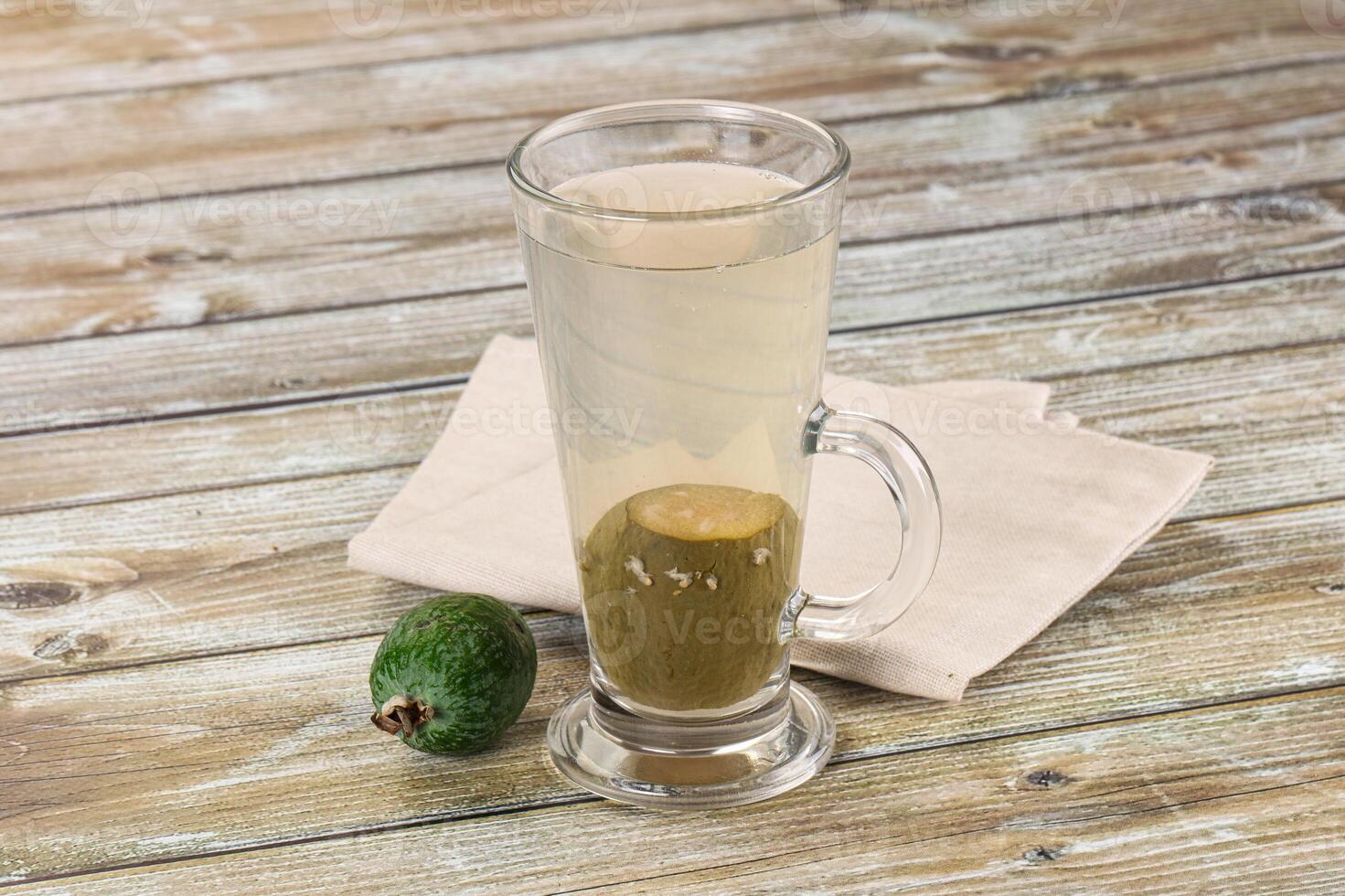A glass of water with an avocado on a napkin photo