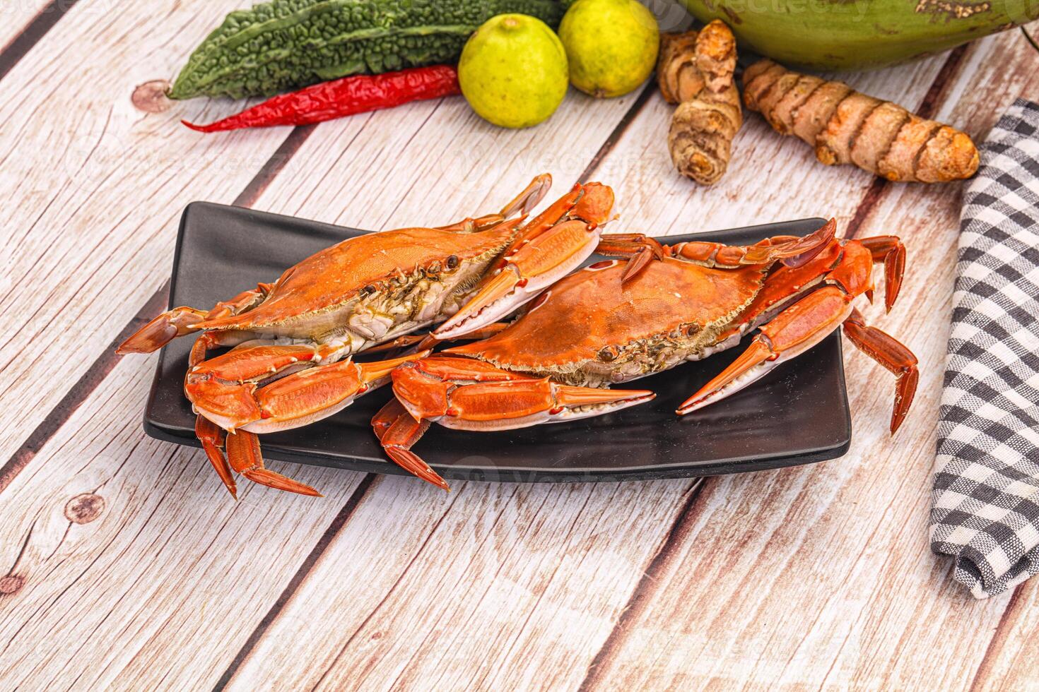 A plate of crabs and other vegetables on a table photo