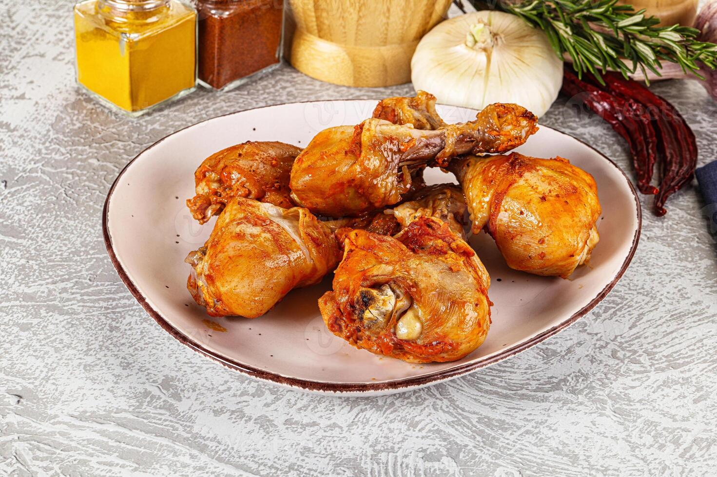 A plate of chicken wings on a table with spices photo