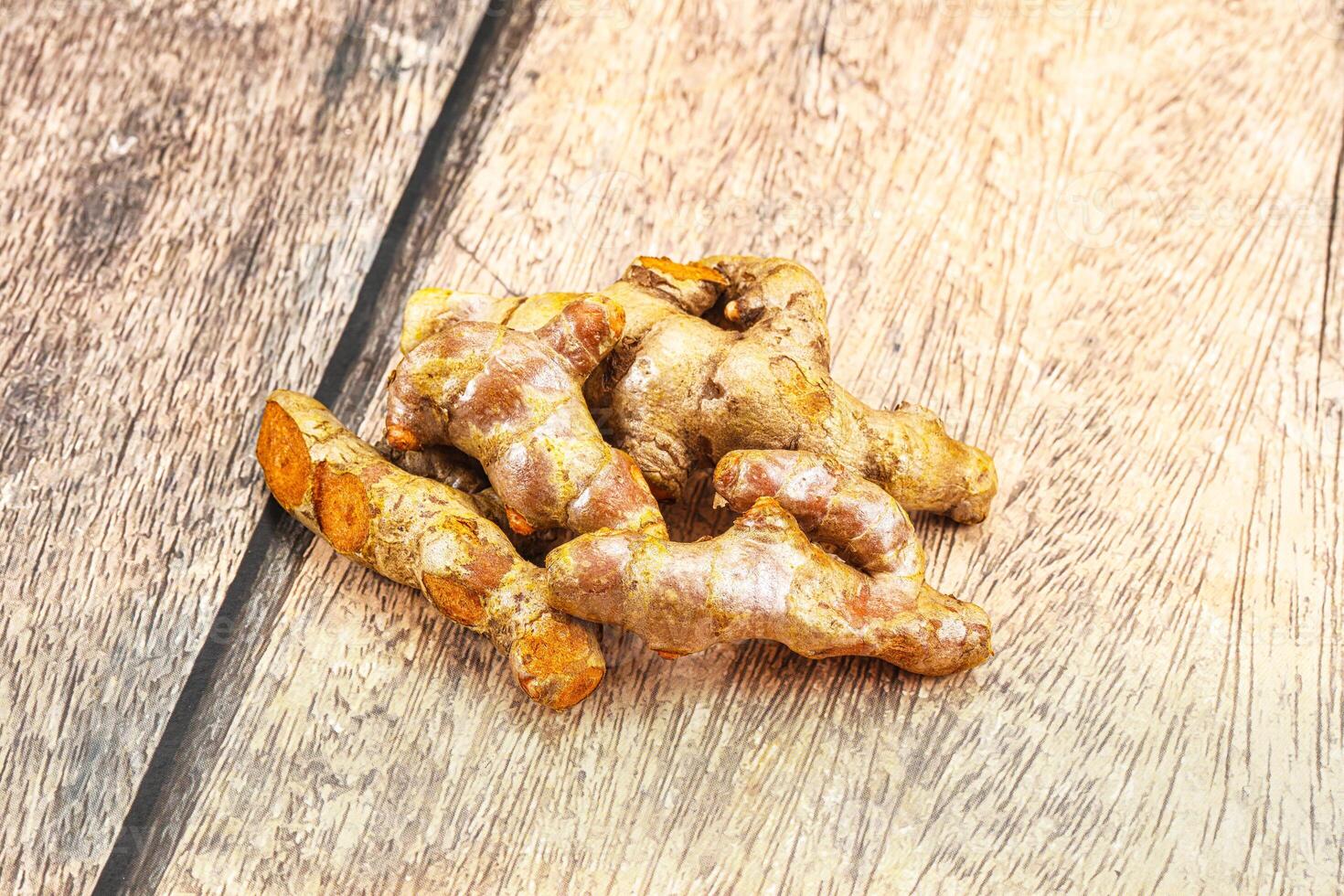 A pile of ginger on a wooden table photo