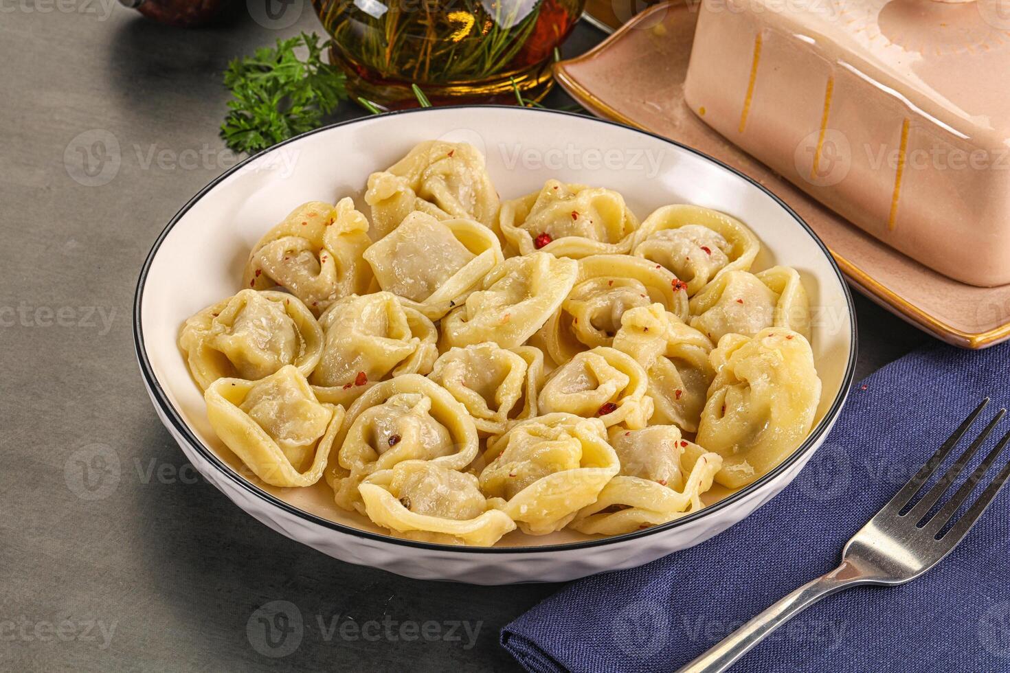 A bowl of pasta with a fork and a knife photo