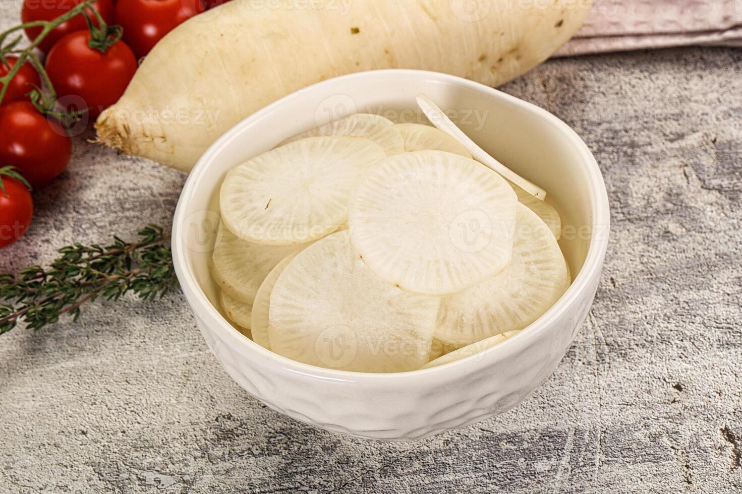 A bowl of sliced potatoes and tomatoes on a table photo