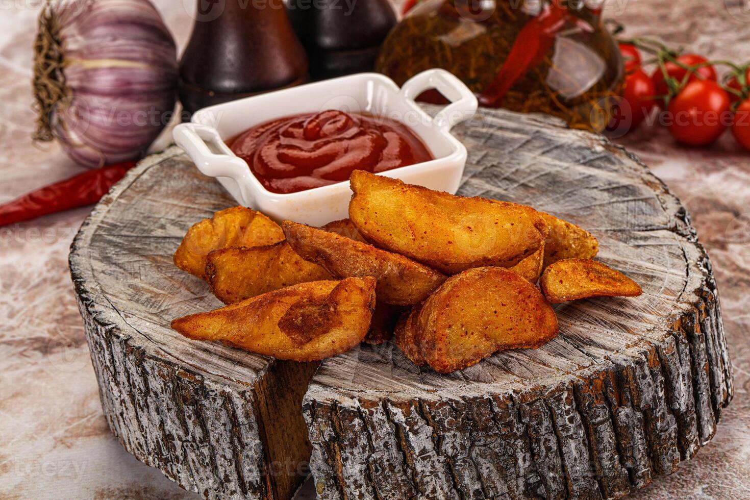 A plate of fries and ketchup on a table photo