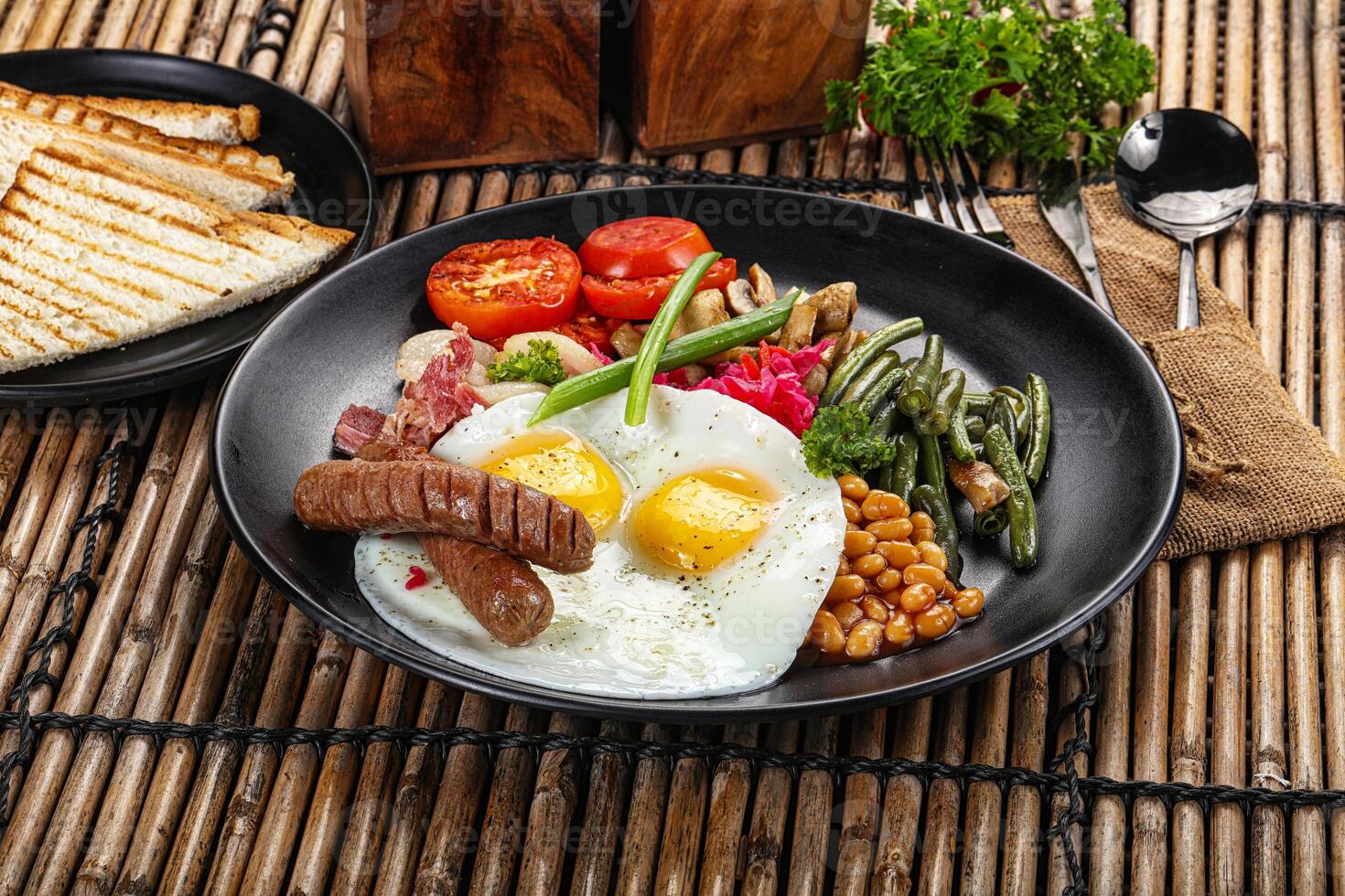 A plate of food with toast, eggs, and beans photo