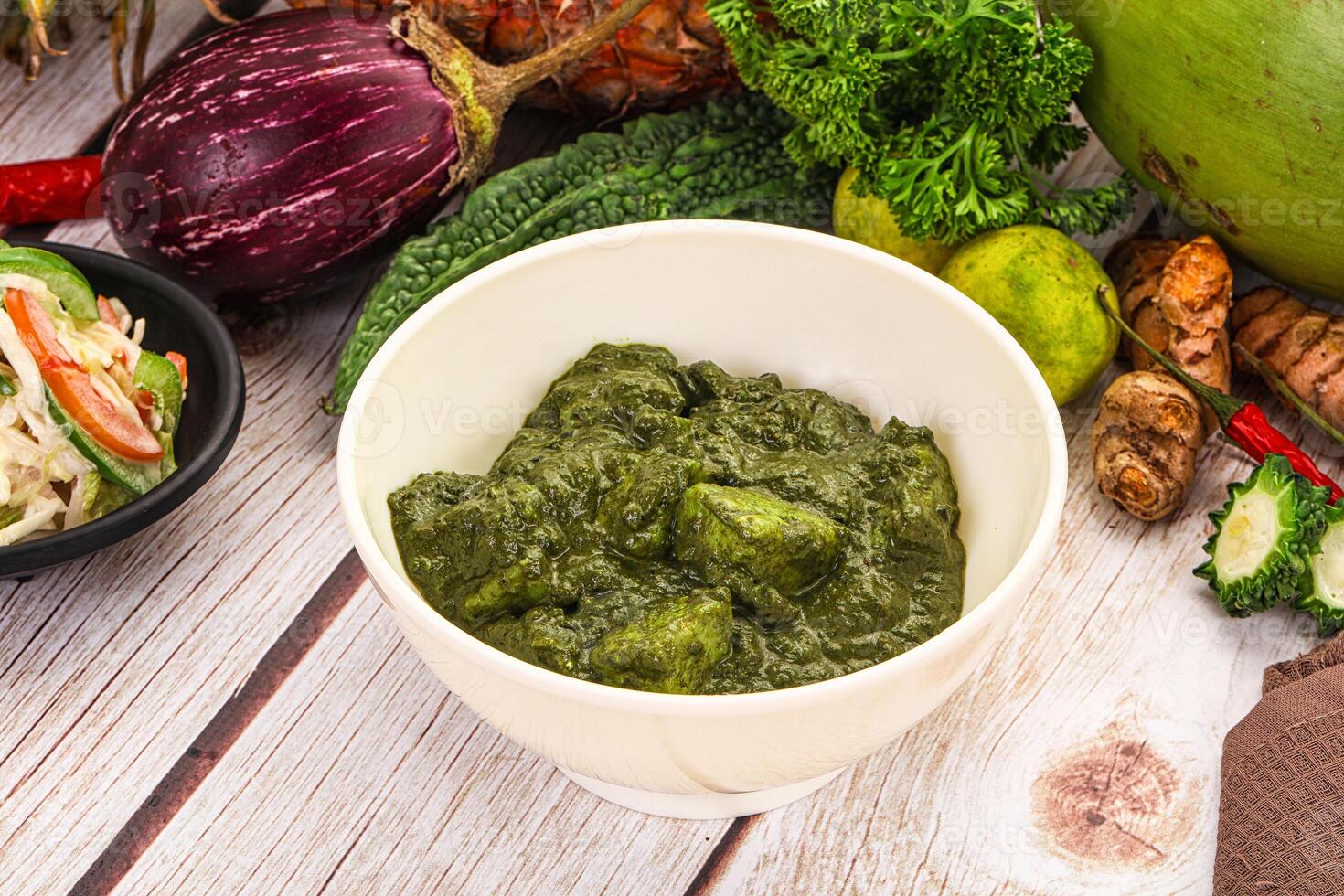 A bowl of green food on a table photo
