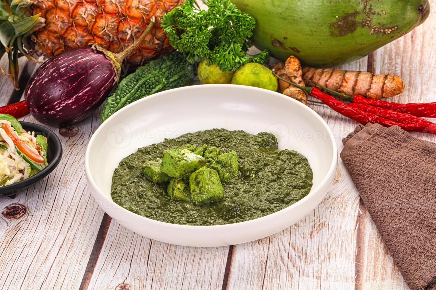A bowl of green food on a table photo