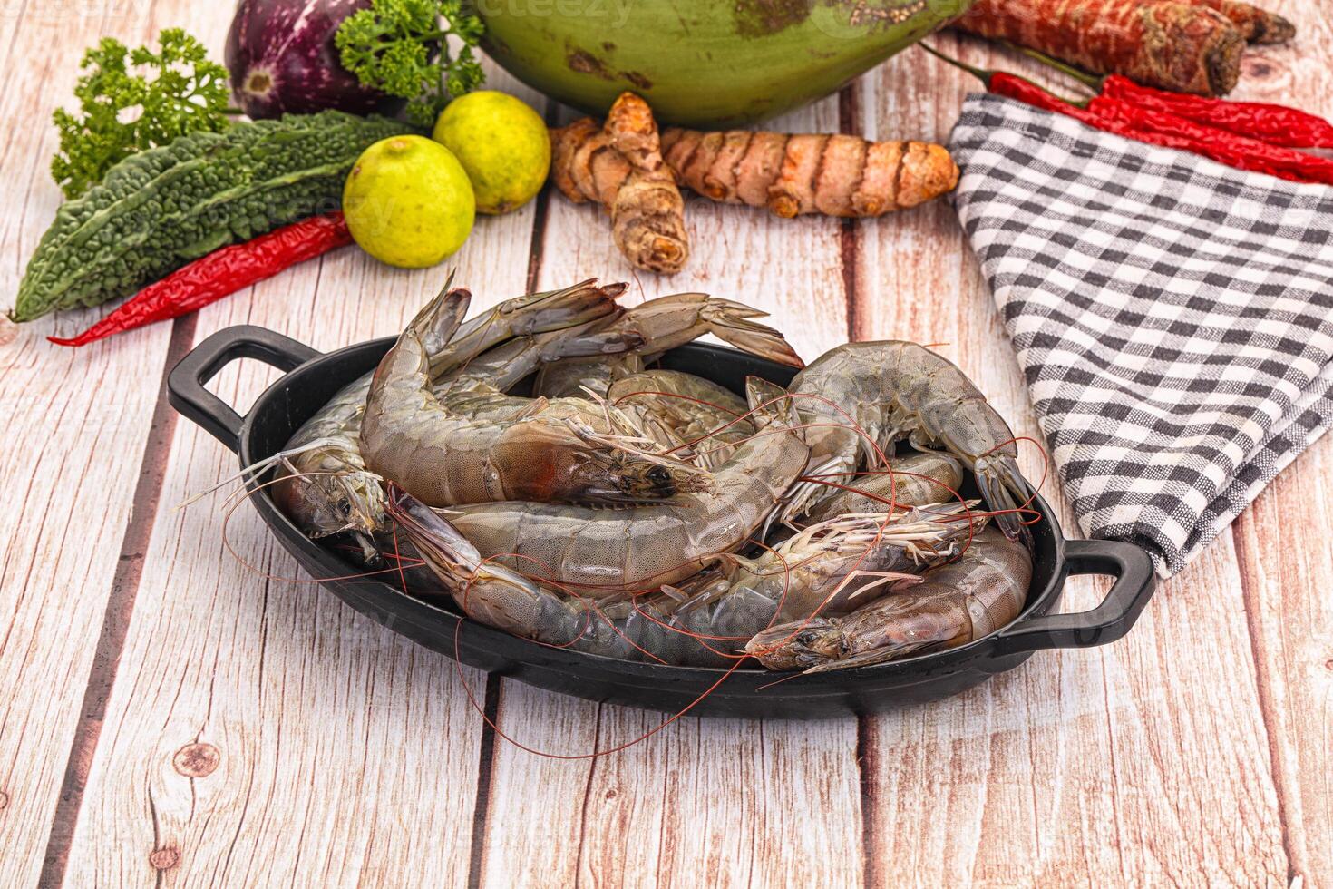 Fresh shrimp in a pan on a wooden table photo