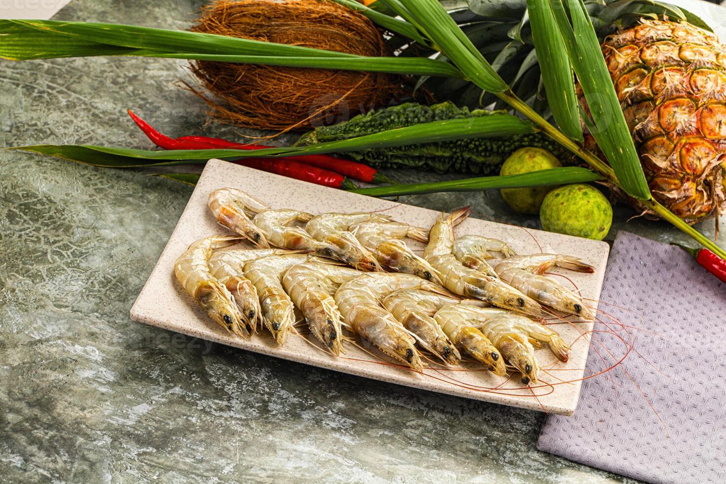 A plate of shrimp and a pineapple on a table photo