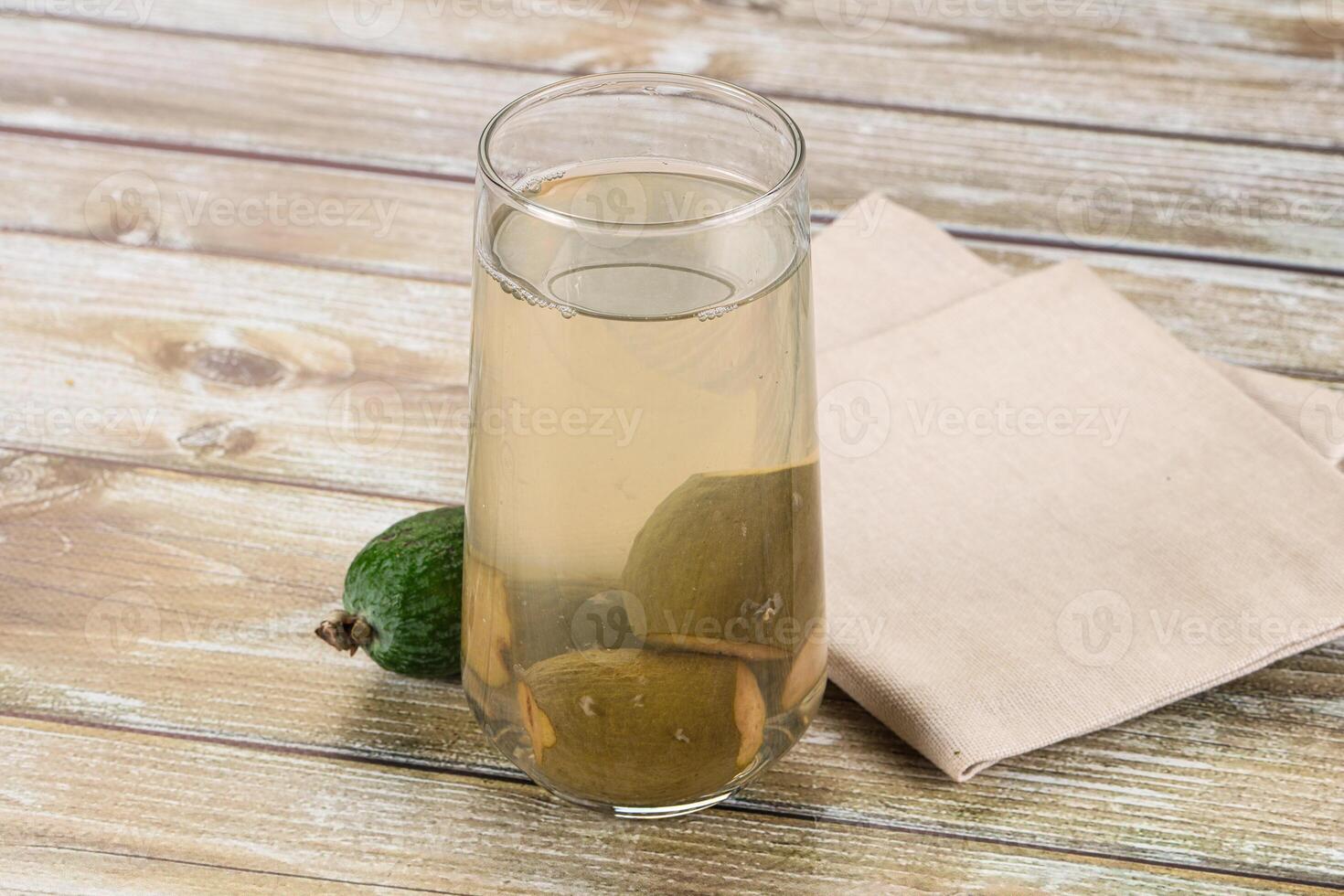 A glass of lemonade with lime slices on a wooden table photo