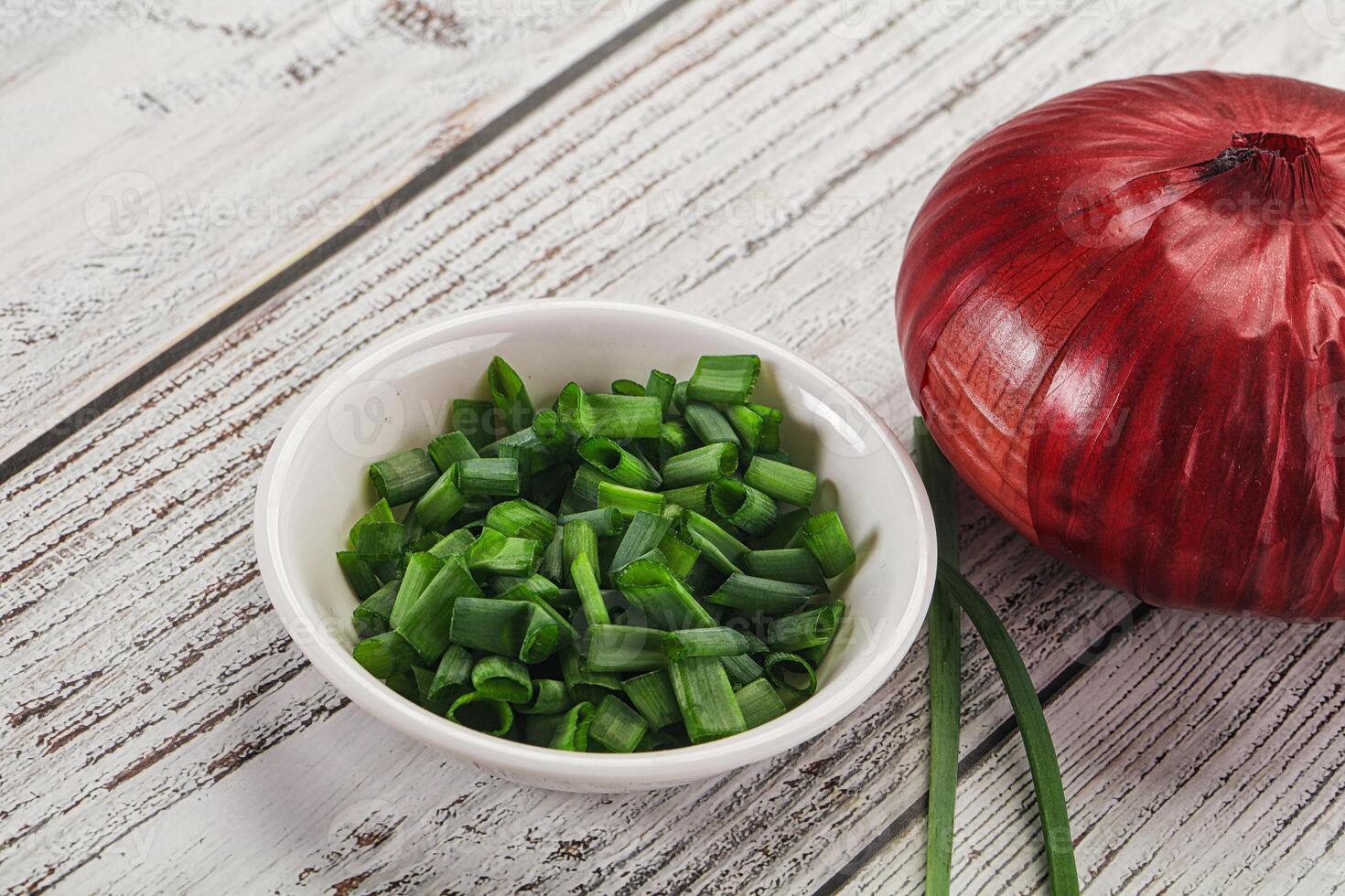 A bowl of chopped onions and a red onion photo