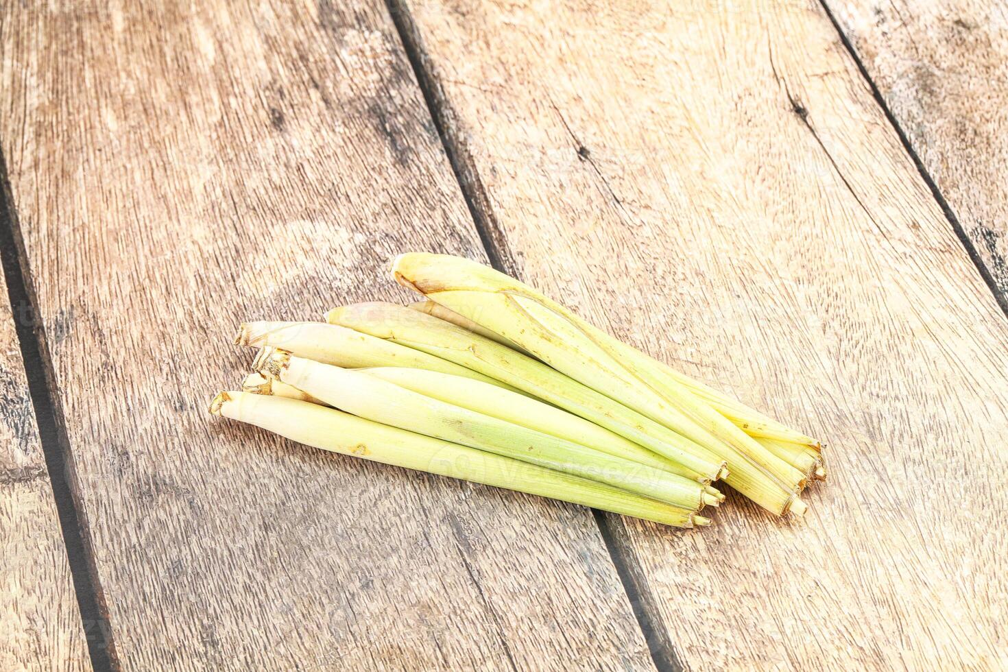 Fresh lemongrass on wooden table photo
