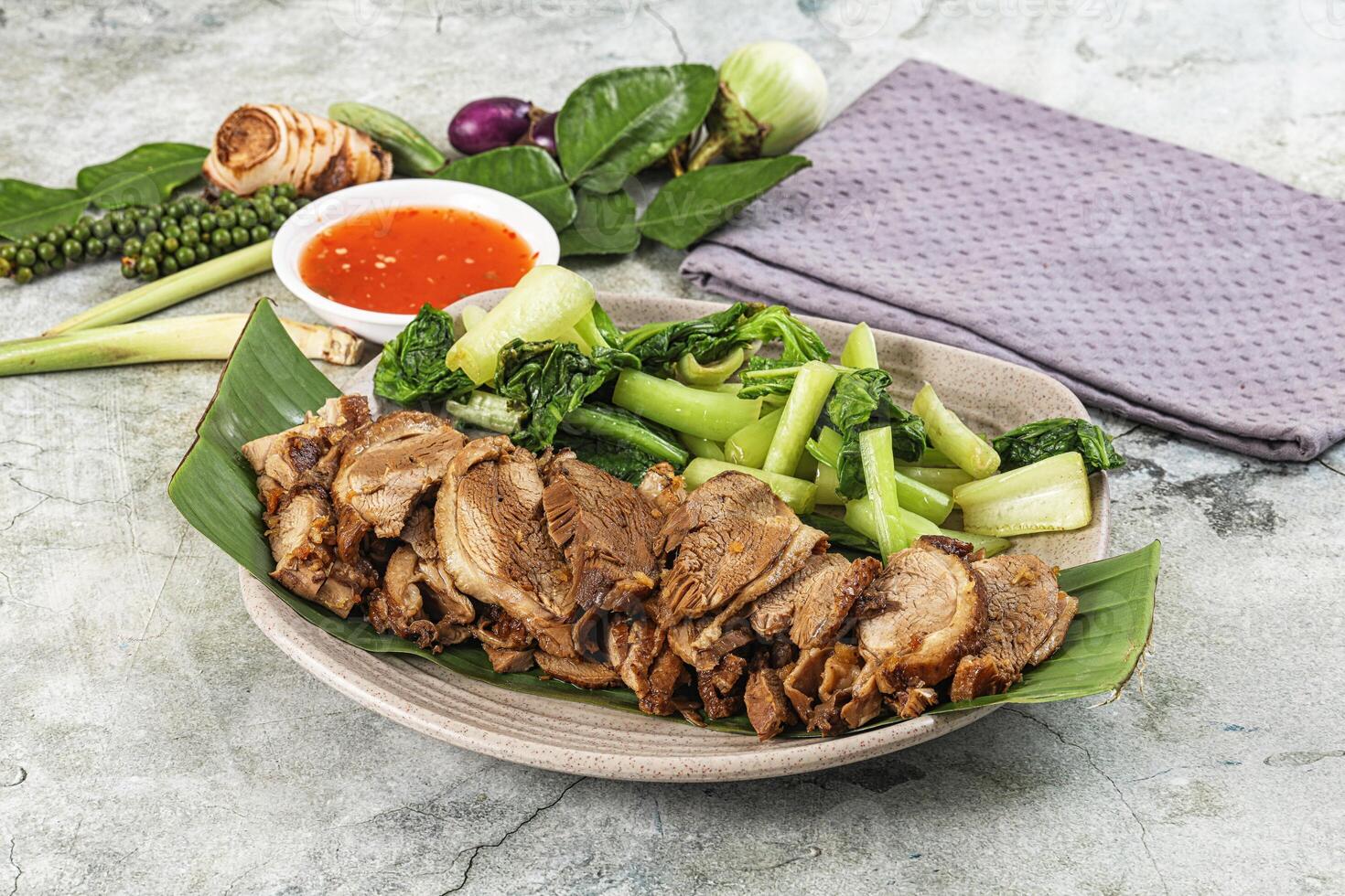 A plate of meat and vegetables on a table photo