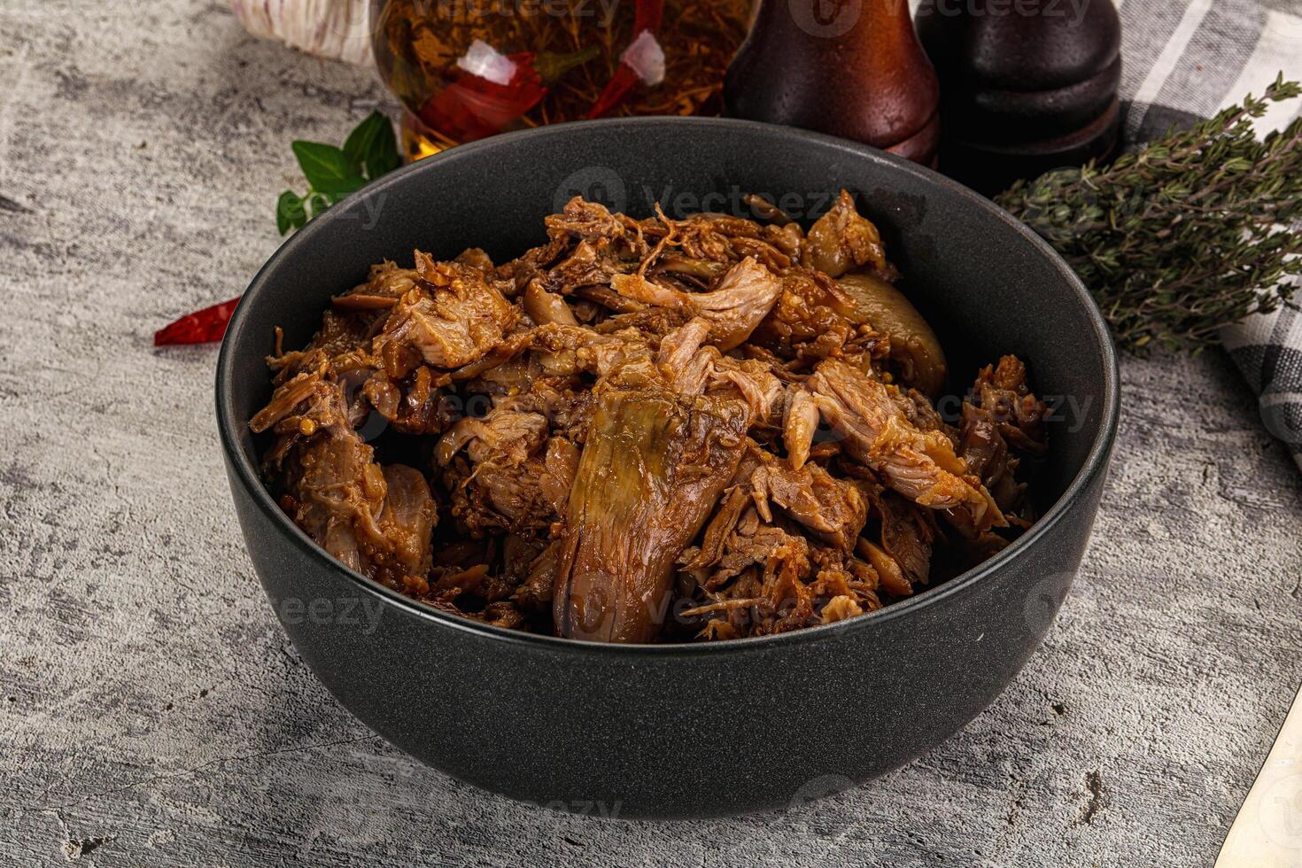 A bowl of pulled pork with spices and herbs photo