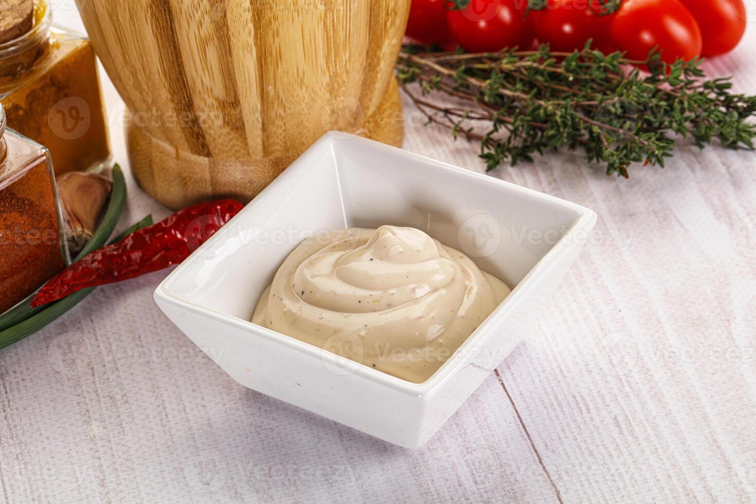 A bowl of dip with spices and herbs photo