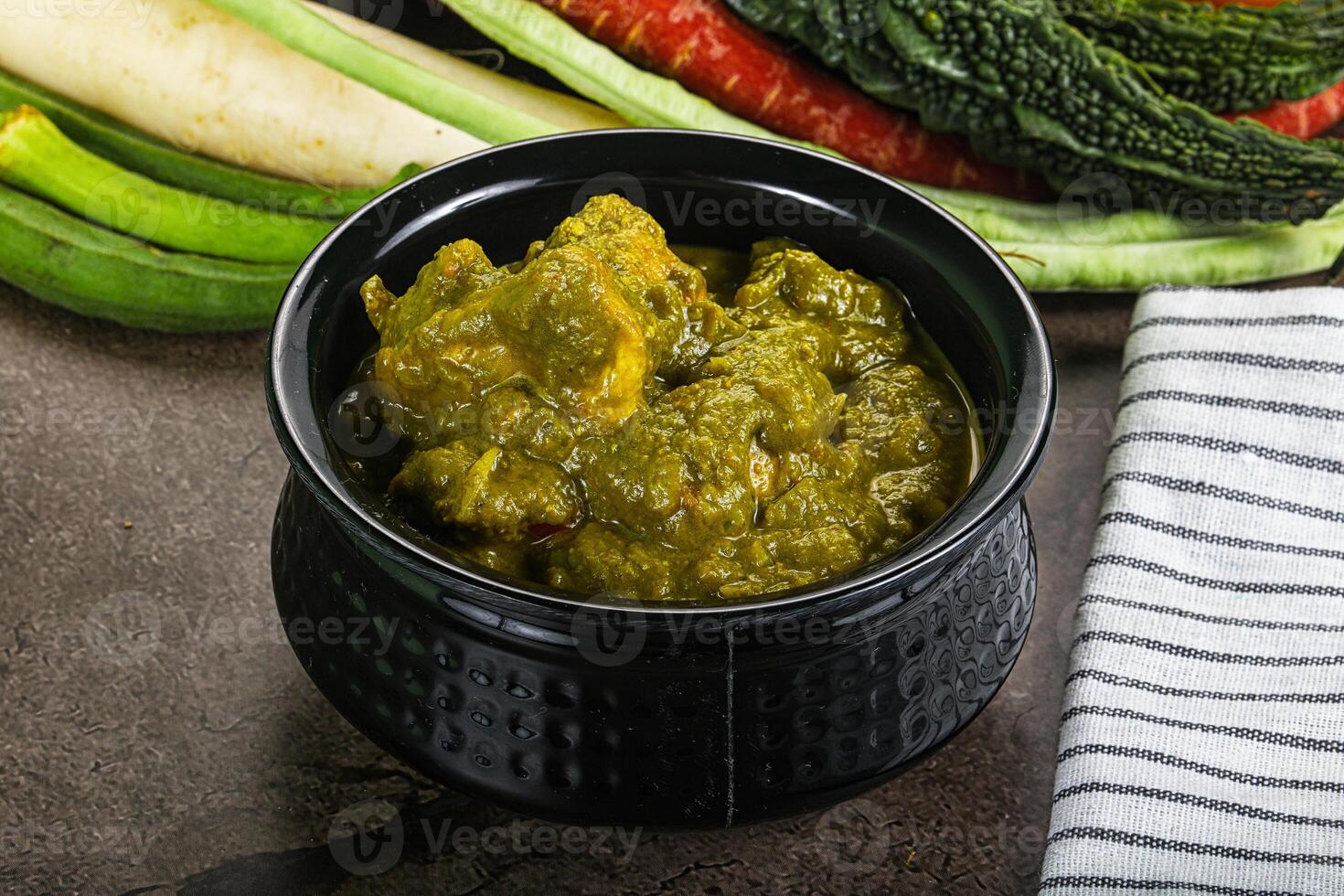 A bowl of food with vegetables and a towel photo
