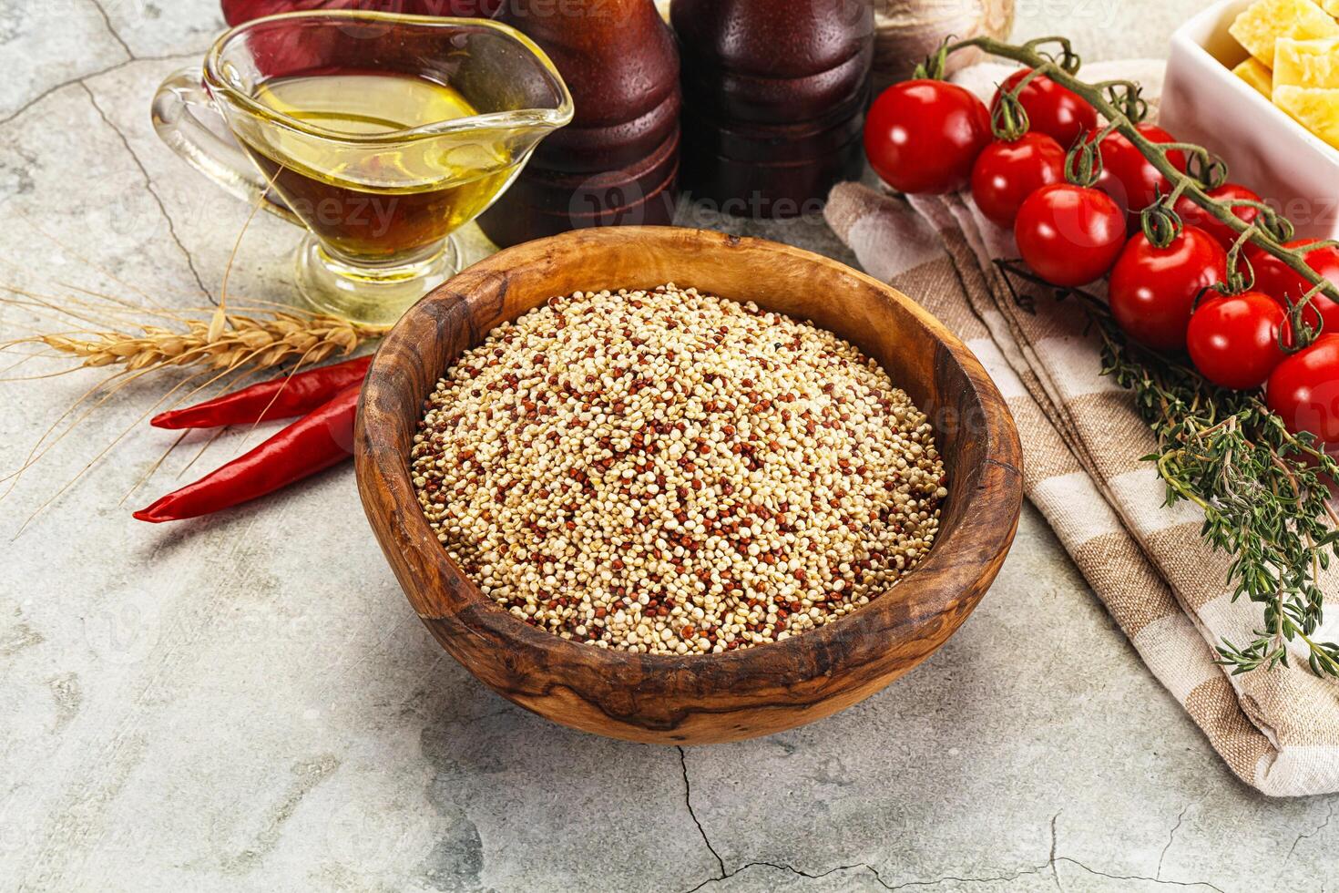 A bowl of quinoa, tomatoes, and spices on a table photo