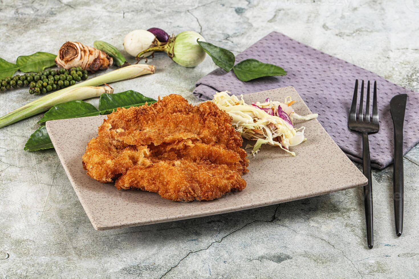 Fried chicken with slaw and vegetables on a plate photo