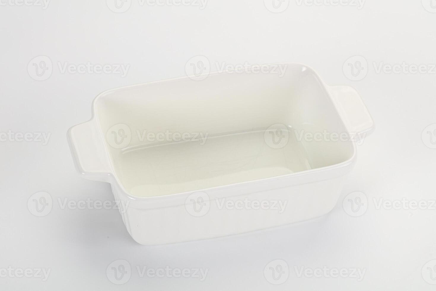 A white rectangular dish with a lid on a white surface photo