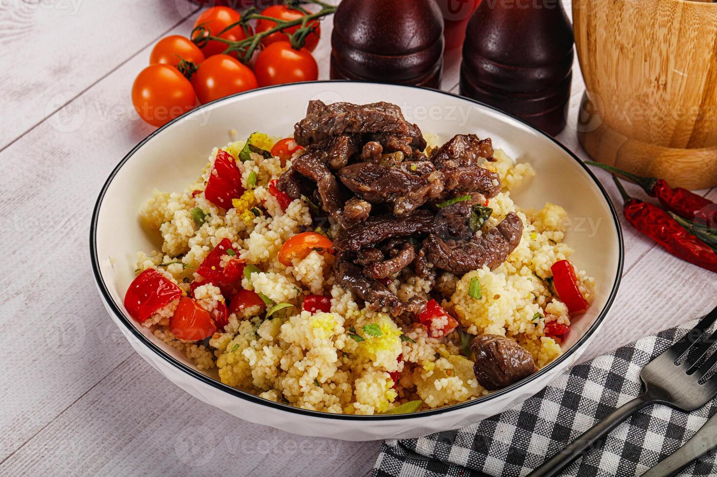 A bowl of food with meat and vegetables photo