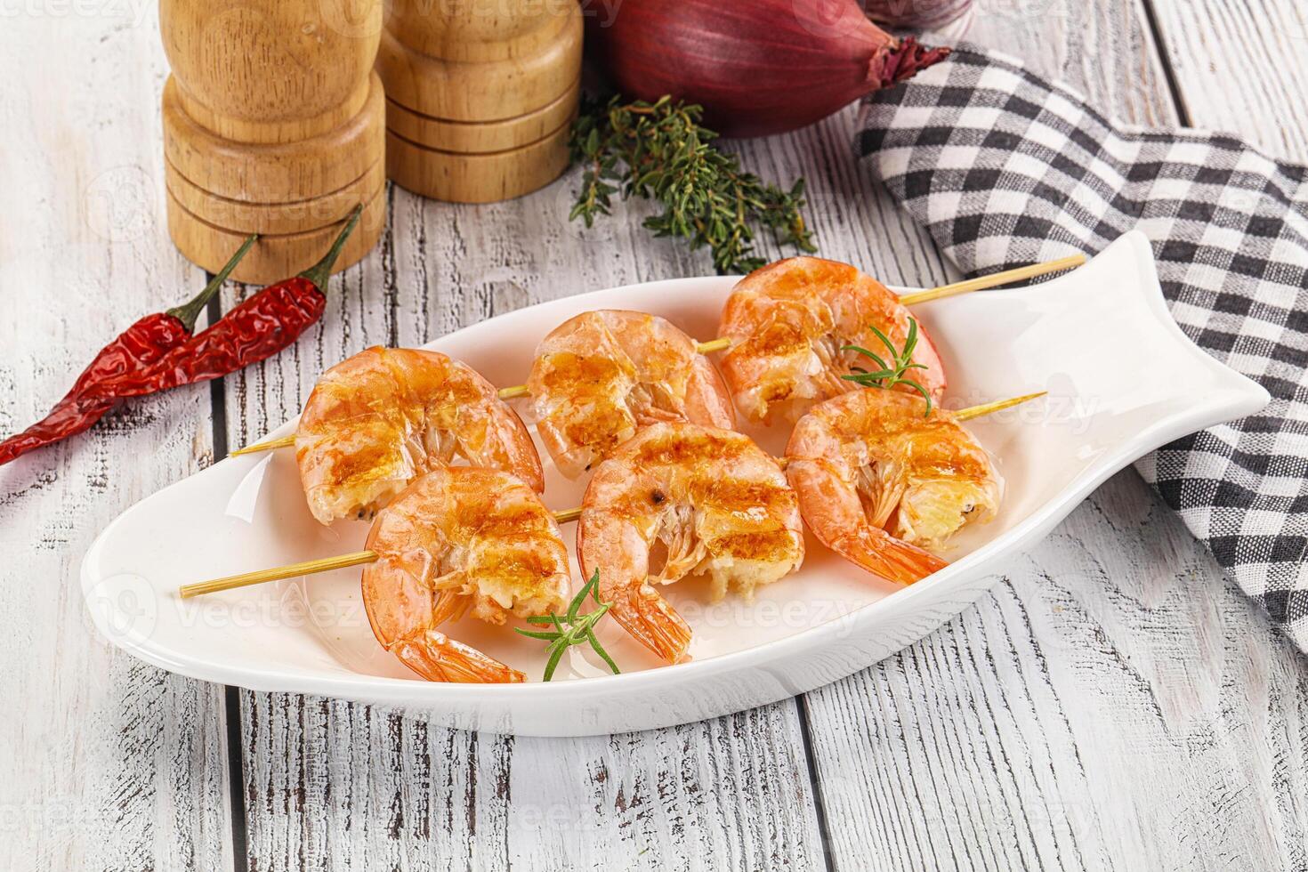 A plate of shrimp on a wooden table photo