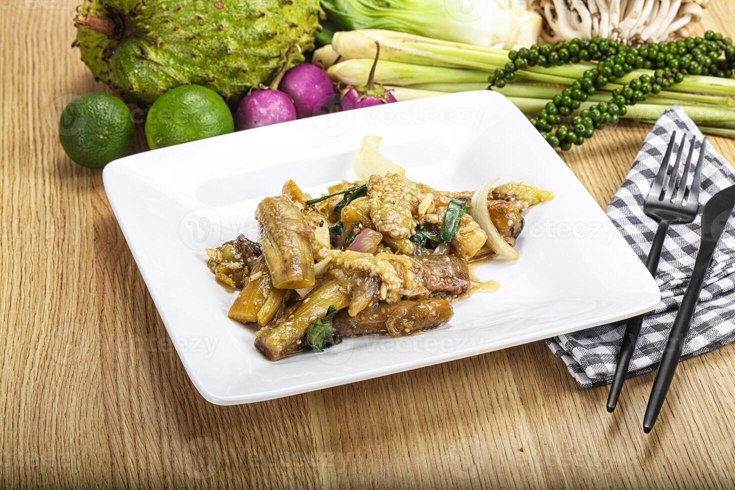A plate of food with a fork and knife on a table photo