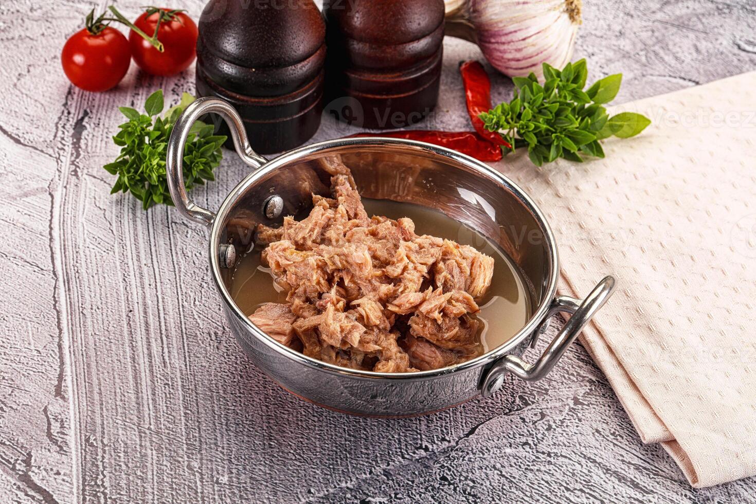A pan with meat and vegetables on a table photo